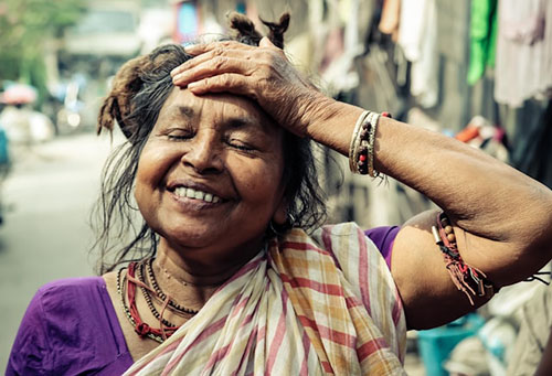 Woman touching her head happily