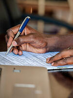 Ugandan person filling a tax document. Image: Kalungi Kabuye / UNU-WIDER