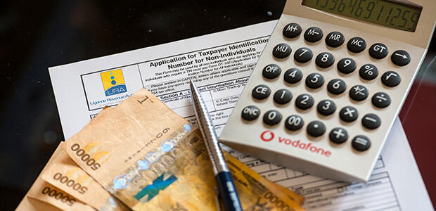 Uganda TIN registration form, calculator, currency, pen. Image: Kalungi Kabuye / UNU-WIDER
